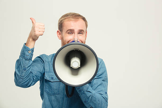 istock Happy man with megaphone showing thumb up 499511098