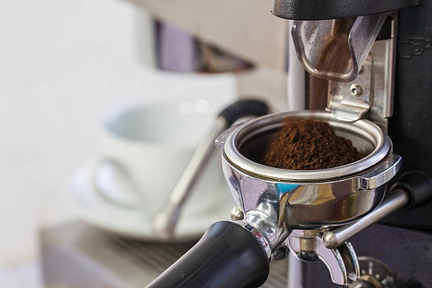 istock coffee grinder grinding freshly roasted coffee beans into a coff 499511110