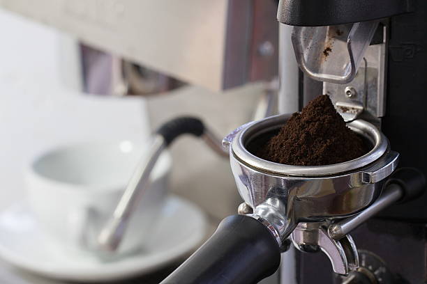istock coffee grinder grinding freshly roasted coffee beans into a coff 499511488