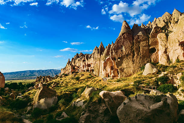 Cappadocia Panoramic image of rugged rock formations riddled with ancient cave houses near Goreme, Cappadocia, Turkey. Thousand of cave dwellings were carved out of the soft volcanic tufa rock in this area. tufa photos stock pictures, royalty-free photos & images