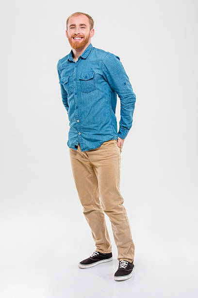 istock Handsome cheerful young bearded man standing and smiling 499511712