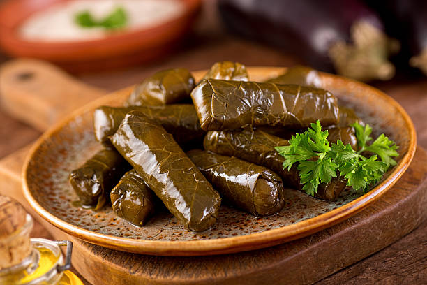 Stuffed Grape Leaves A plate of delicious stuffed grape leaves with parsley garnish. meze stock pictures, royalty-free photos & images