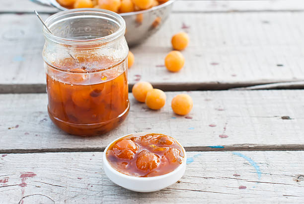 istock homemade jam of yellow plum on a white board 499512890
