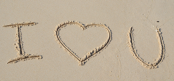 Text I love you draw on beach