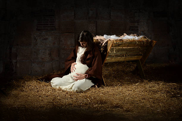 Mary and the Manger on Christmas Eve Pregnant Mary leaning on the manger on Christmas Eve virgin mary stock pictures, royalty-free photos & images