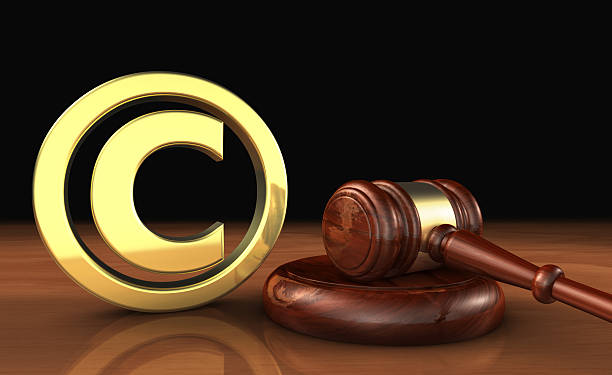 Copyright Icon And Gavel Law Symbol Copyright intellectual property and digital copyright laws conceptual illustration with symbol and icon and a gavel on black background. Patent Cooperation Treaty stock pictures, royalty-free photos & images