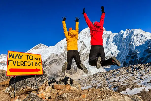 Young women jumping next to the signpost "Way to Mount Everest Base Camp" in Mount Everest National Park. This is the highest national park in the world, with the entire park located above 3,000 m ( 9,700 ft). This park includes three peaks higher than 8,000 m, including Mt Everest. Therefore, most of the park area is very rugged and steep, with its terrain cut by deep rivers and glaciers. Unlike other parks in the plain areas, this park can be divided into four climate zones because of the rising altitude.http://bem.2be.pl/IS/nepal_380.jpg