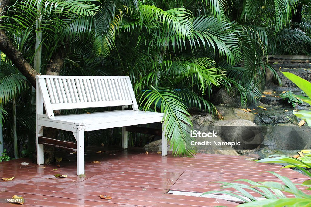 White bench in garden. White bench wooden in garden for background and design. Beauty Stock Photo