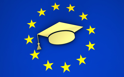 European education, university and school system in Europe concept with EU flag and college hat symbol.