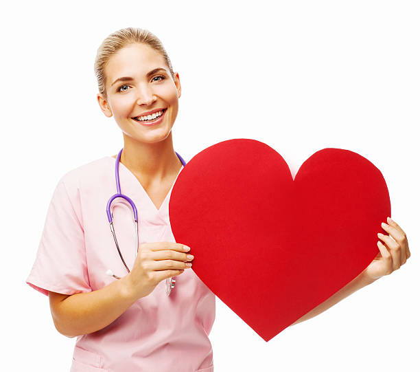 istock Happy Female Nurse Holding Heart Shape 499515977