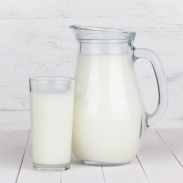 istock Milk glass and jar on table 499516258