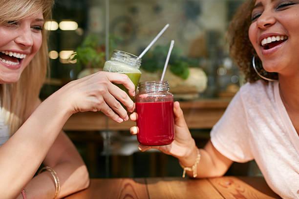 istock Young friends toasting drinks at sidewalk cafe 499516648