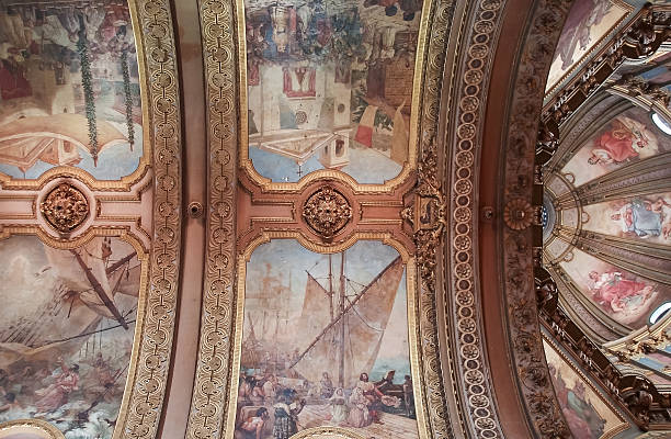 Look up at the ceiling and lights inside the church.