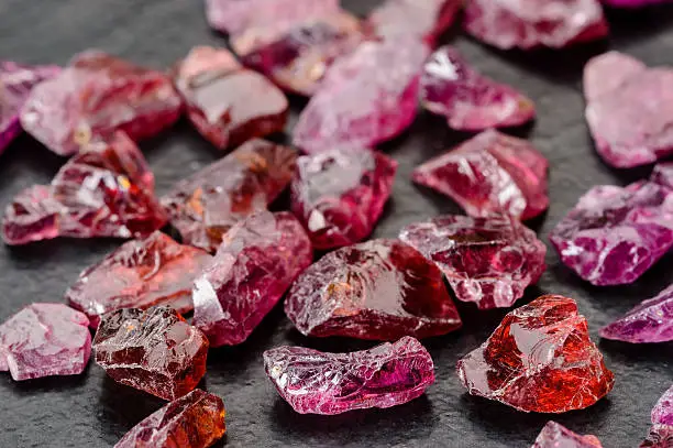 Set of uncut, rough and raw Rhodolite garnets.