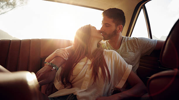 istock Couple on road trip sharing a romantic kiss 499517670