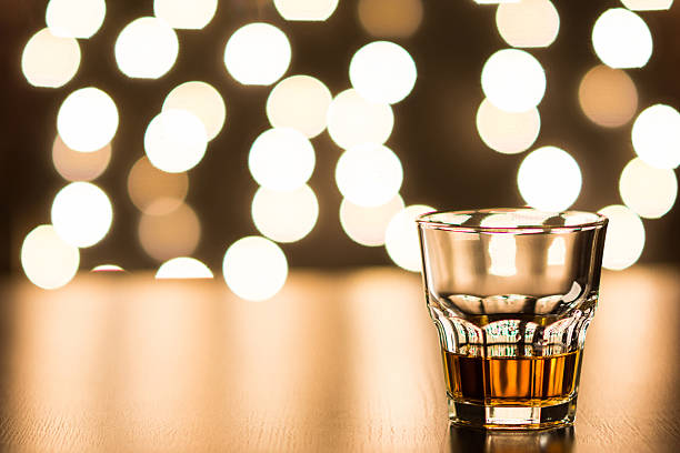 istock Glass with whiskey on wooden table 499518022