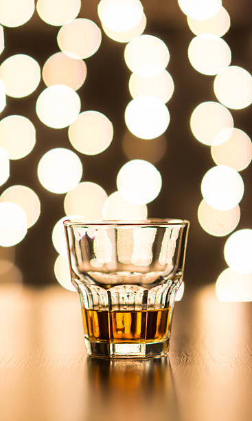 istock Glass with whiskey on wooden table 499518166