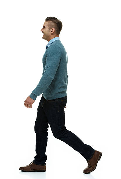 istock Side view of happy young man walking 499518377