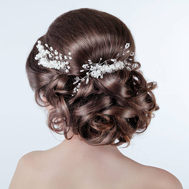 Brown hair styling. Brunette girl with curly hairstyle Brown hair styling. Brunette girl with curly hairstyle with barrette. Bride photo hairstyle bride jewelry women stock pictures, royalty-free photos & images