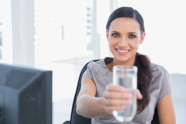 istock Smiling gorgeous secretary offering water 499519797