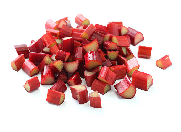 chopped red rhubarb chopped red rhubarb on white background rhubarb stock pictures, royalty-free photos & images