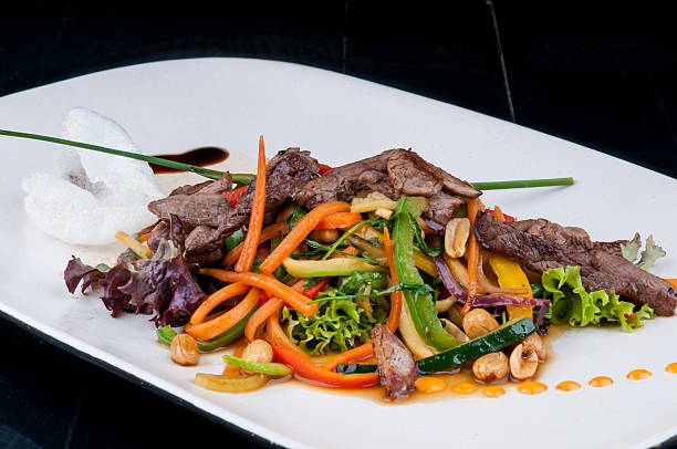 istock Chopped meat with vegetables served on a white plate 499519960