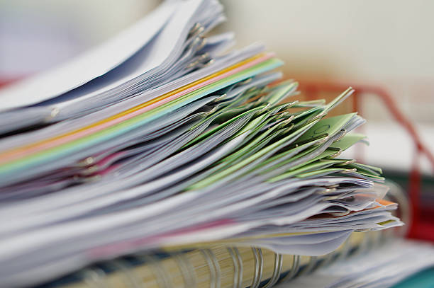 istock Pile of documents and notebook in red basket 499520006
