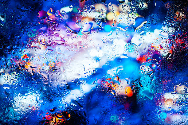 istock Night city through a wet window 499520512