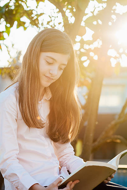 istock Girl Reading in the Garden 499521122