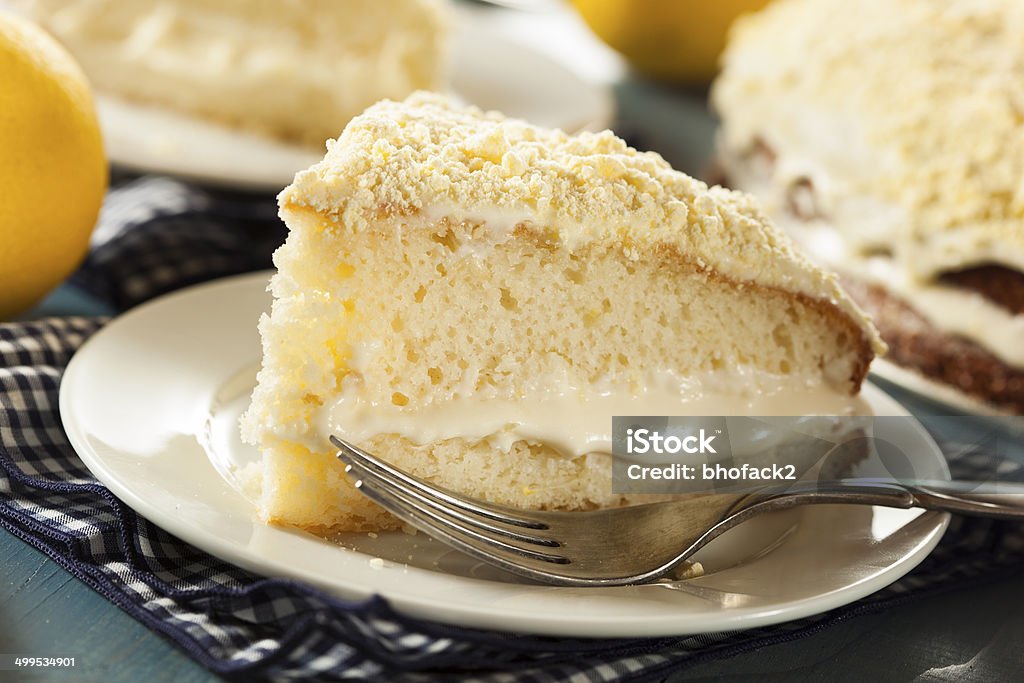 Homemade Lemon Cake with Cream Frosting Homemade Lemon Cake with Cream Frosting on a Background Cake Stock Photo