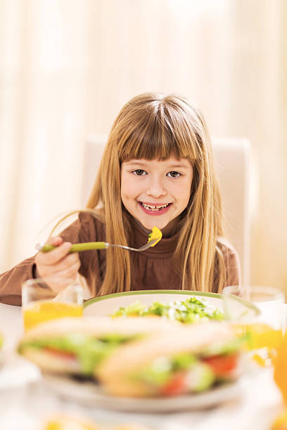 istock Little girl eating salad. 499535075