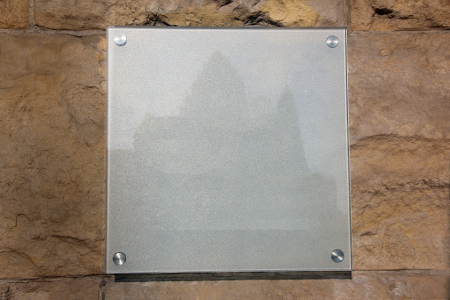 glass grey plate with a castle image on a stone background