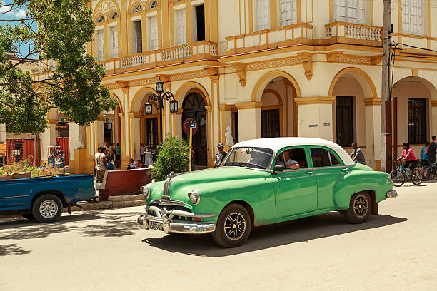 Beautiful green retro car in cuban town stock photo