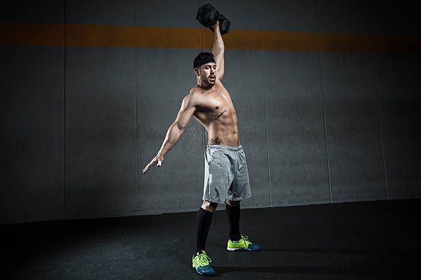 kettlebell snatch strength exercise with weight ganar stock pictures, royalty-free photos & images