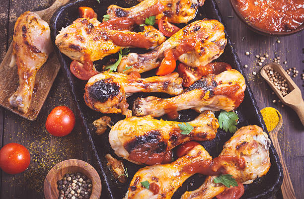 istock Spicy chicken drumsticks on serving pan closeup 499538608