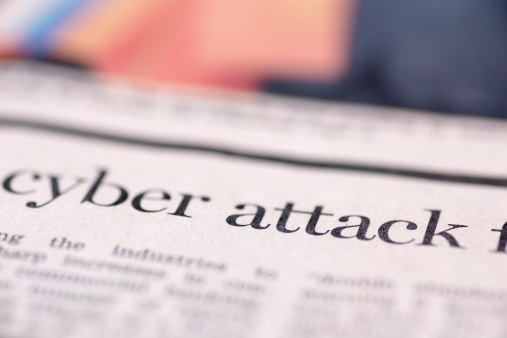 Cyber attack written newspaper, shallow dof, real newspaper.