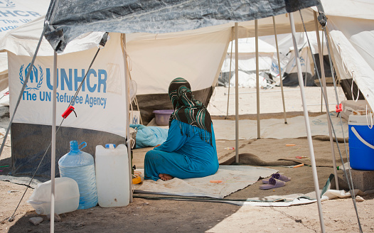 Ankawa, Kurdistan, Iraq - June 22, 2014: Woman in a tent in an IDP camp. This camp is 15 km from Mosul away and it is set up on an empty field. This camp collects people from the region of Mosul after the ISIS invated the city.