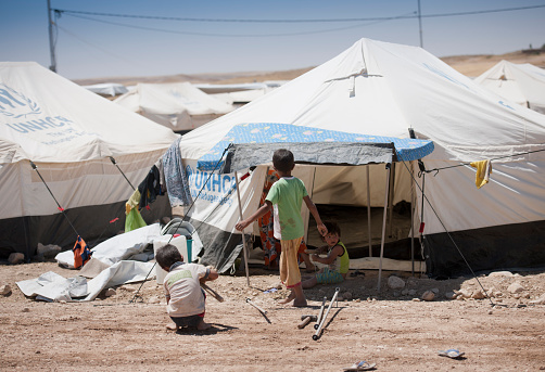Ankawa, Kurdistan, Iraq - June 22, 2014: Children in a tent in an IDP camp. This camp is 15 km from Mosul away and it is set up on an empty field. This camp collects people from the region of Mosul after the ISIS invated the city.