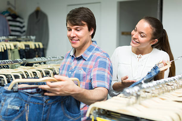 istock Couple buying blue jeans at store 499539404