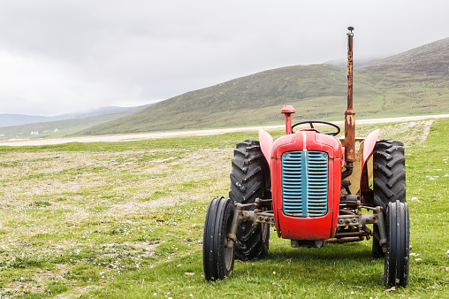 Vintage red tractor in a field in UK
