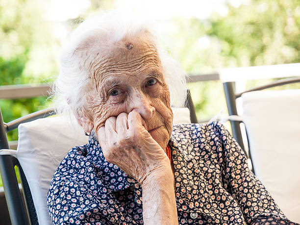 senior lady looking at the camera smiling stock photo