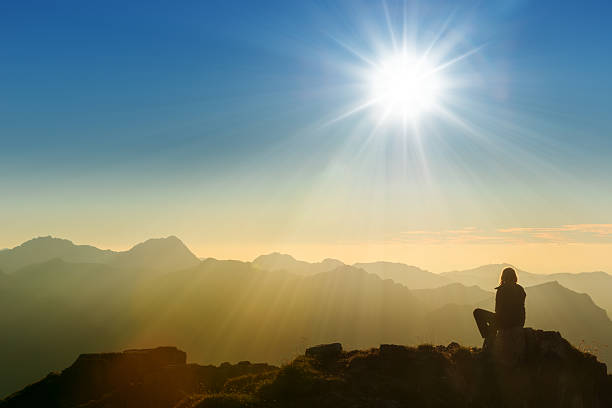 istock lonely sad person sitting on mountain summit at dawn 499540354