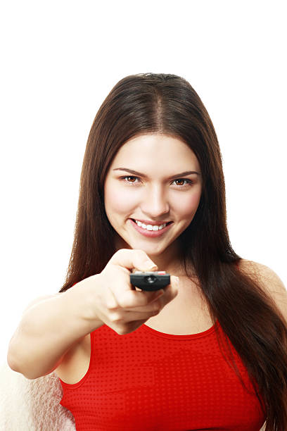istock woman holding TV remote control 499541734