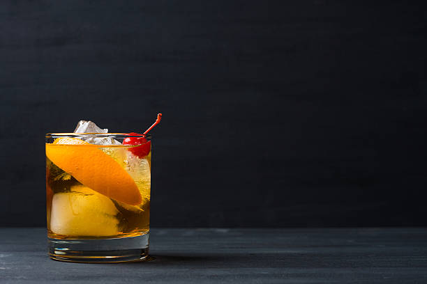 Old fashioned cocktail Old fashioned cocktail with cherry and orange peel sour taste stock pictures, royalty-free photos & images