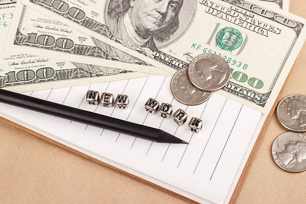 istock Money and notes to the word new work 499543560