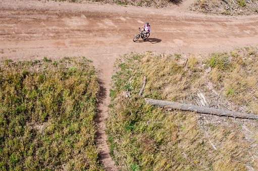 Vail, Colorado, USA - October 2, 2015: Vail, Colorado is world-renowned as a winter ski resort. In the Spring and Summer, the famous ski trails are opened up and used as runs for mountain biking. This biker is making his way down the slope after riding to the top of the mountain via the Eagle Bahn Gondola. Vail is an amazing location for mountain biking. Miles of scenic trails for every type of bike rider. Vail mountain offers up adventure, challenge, and enjoyment for families, first timers and experts.