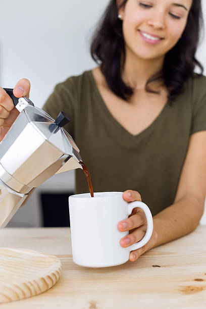 istock Beautiful young woman drinking coffee at home. 499545514