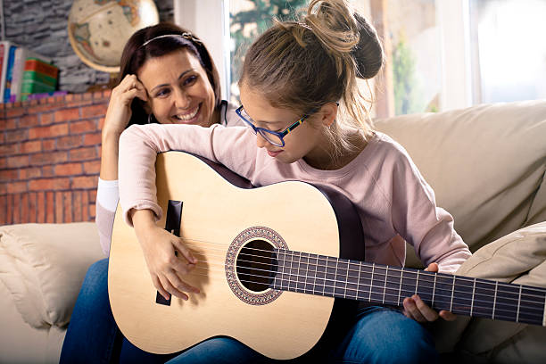 istock Girl playing guitar 499545746