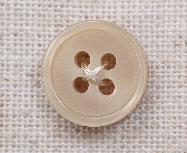 istock Close-up of Beige Button sewn on Fabric 499547358