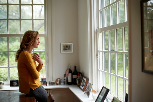 Thoughtful woman having coffee in cottage photo